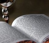 Open Torah and silver wine cup. © webking/iStockphoto