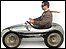Man driving toy car
