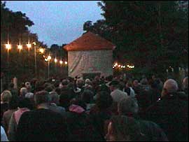 Candlelit procession following the walking house