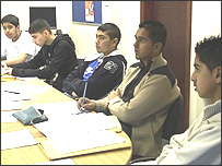 Five young muslim men at a desk