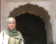 Shagufta Yaqub in front of an arched mosque doorway in Lahore