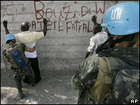 Soldados brasileiros da força da ONU no Haiti revistam suspeitos em Porto Príncipe