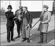 Policeman checks rabbit kills in Bratton Fleming