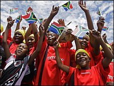 South African children wave flags ahead of the draw for the 2010 World Cup