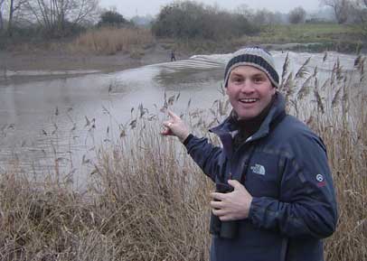 Mike Dilger watches people surf the Severn bore