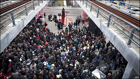 Delegates and journalists wait to get their accreditations at the entrance of the Bella Center as they arrive for the Copenhagen climate conference