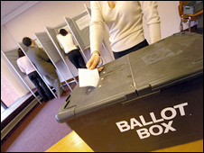 A woman votes at a UK polling station
