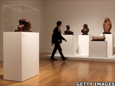 Man walks past Henry Moore exhibition at the Tate Britain