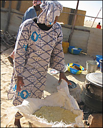 Madame Mohammed watches the steamed couscous