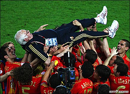 Aragones is hoisted aloft by his players