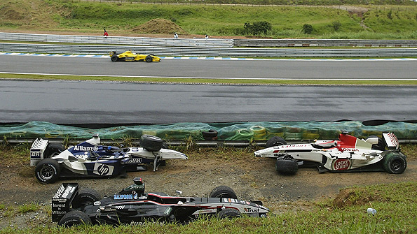 Eventual winner Giancarlo Fisichella follows the safety car as they pick their way through the debris left by massive crashes involving Mark Webber and Fernando Alonso at the 2003 Brazilian Grand Prix