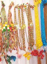 Colourful rakhis hanging on a wall ready to be exchanged