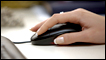 A woman's hand and a computer mouse