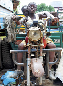 Two boys imagine riding at high speed on the remains of this powerful motorbike