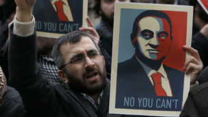 Man holding an anti-Mubarak sign in Cairo, Egypt