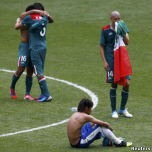 Brazil's Neymar, sitting down at the end of the match, can only look on as Miguel Ponce, Hector Herrera and Jorge Enriquez celebrate winning gold 