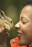 Woman hugging nervous-looking rabbit