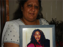 mother holding photo of murdered daughter