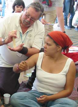 Keith Holloway teaches a visitor how to play the bones