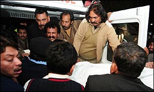 Supporters of the PPP party with the body of Samaan Tasweer