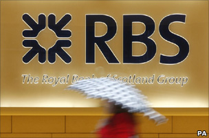 Lady walks past RBS sign