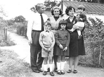 The Mazurek family outside one of the family huts at Penley.