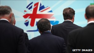 Party leaders' backs looking at the conference stage