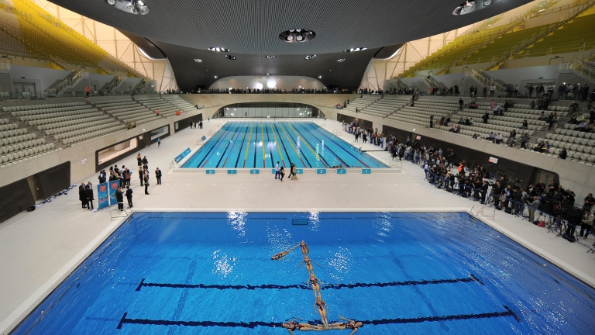 Members of a synchronised swimming team form the shape of a number 
