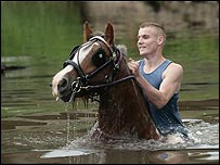 Riding a horse through the water