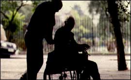 A carer looks after an elderley person
