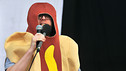 Huw in a hot dog on stage at Reading Festival