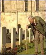 Richard Todd looking at grave stones
