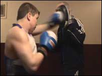 Ashley gets a few punches in with his trainer 