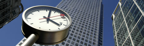 Clock by skyscraper
