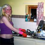 Sara doing the washing up in her student kitchen