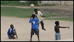 Local children play football in Victoria Park in Cape Coast, Ghana
