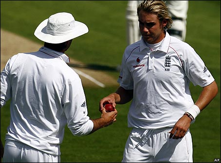 Michael Vaughan hands the ball to Stuart Broad