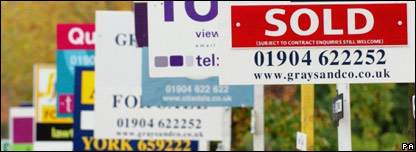 'For sale' signs outside houses on a UK street