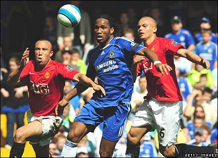 Manchester United's Mikel Silvestre and Wes Brown; Chelsea's Didier Drogba