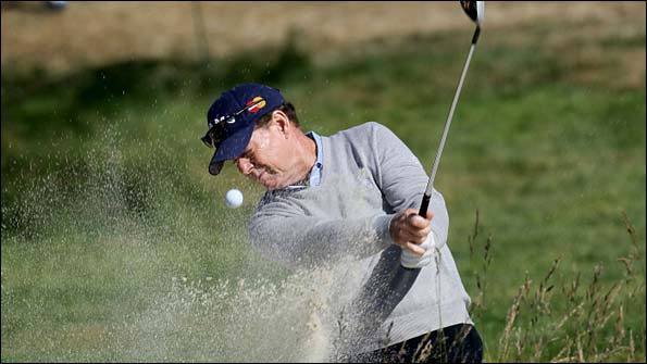 Tom Watson hits a shot out of a bunker during a practice round at Pebble Beach.jpg