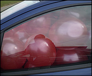 Car full of red balloons for Comic Relief