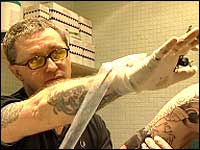 Louis Malloy creating a tattoo