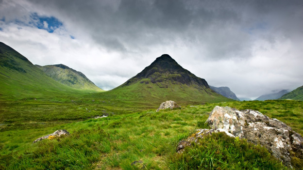View of Glencoe from Glencoe Valley under a grey, threatening sky