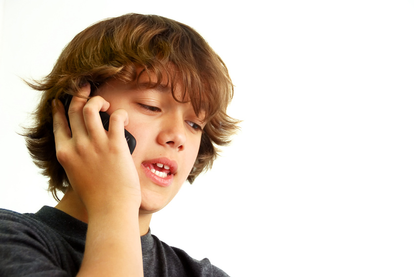 Teenage boy talking on mobile phone @ goldenangel - fotolia