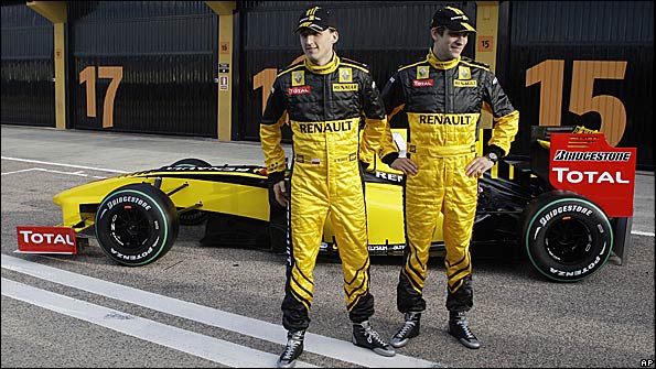 Robert Kubica and Vitaly Petrov pose with the new Renault F1 car at Valencia