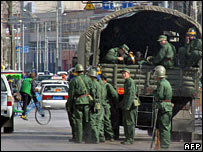 Chinese soldiers disembark from a truck in Lhasa on 21 March 2008