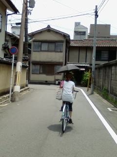 Lady on a bicycle with umbrella