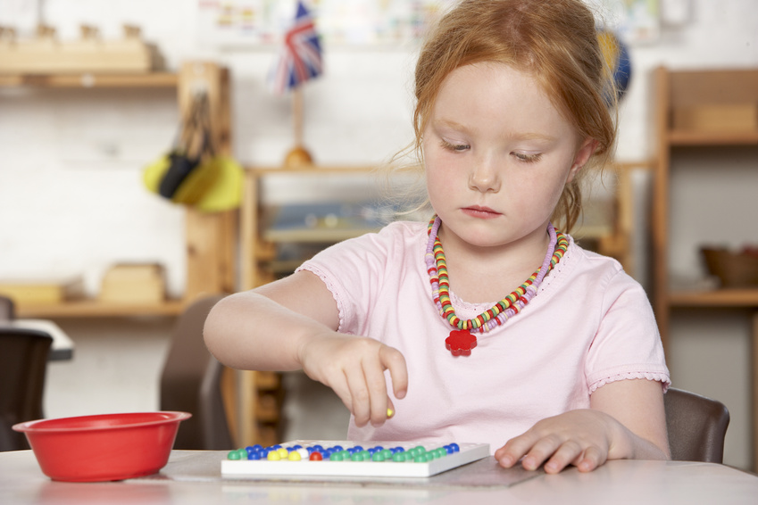 young girl playing at Montessori pre-school @ Monkey Business - fotolia.com