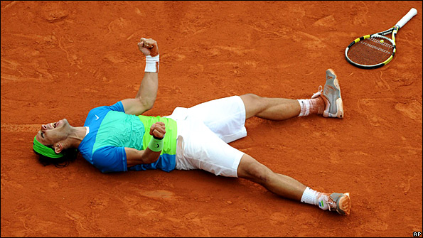 Rafael Nadal collapses to the ground after winning his fifth French Open title