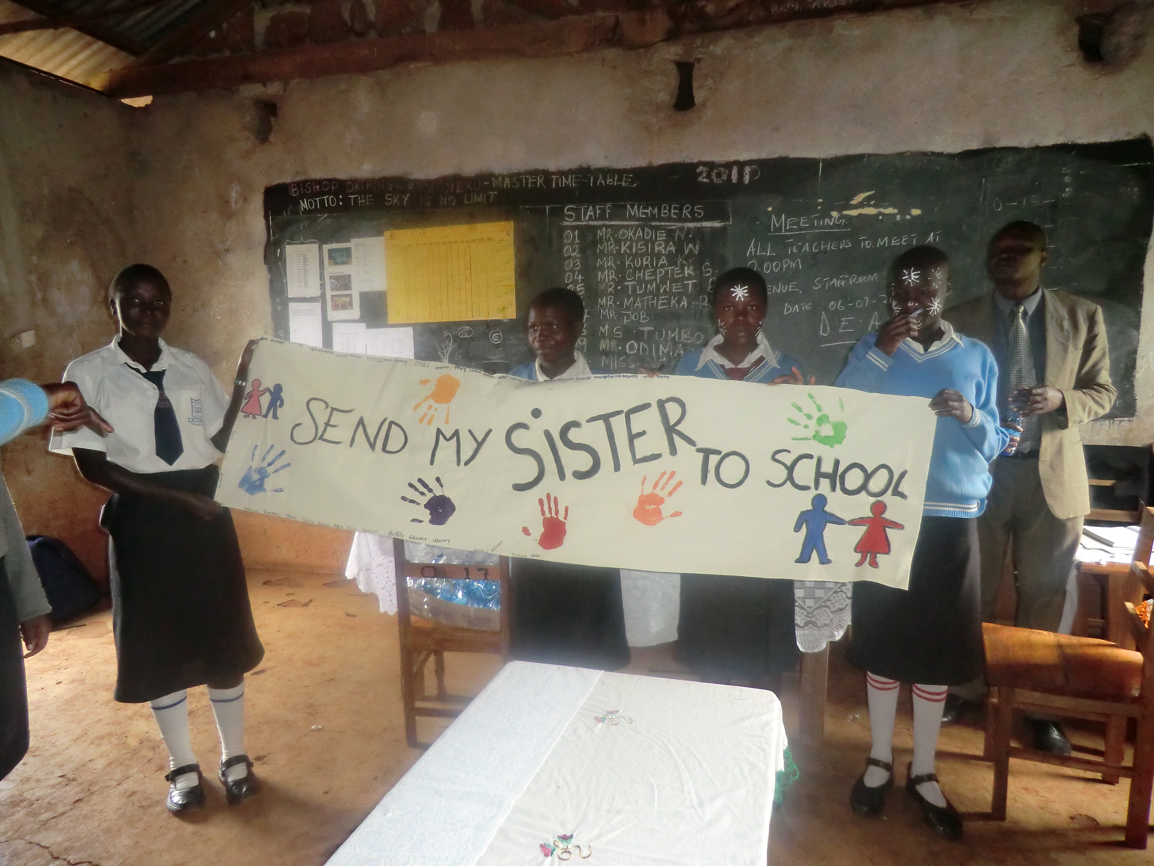 Kenyan students signed the 'Send My Sister to School' campaign banner